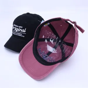 Detail view of cotton baseball caps in black and dusty pink with high quality embroidery
