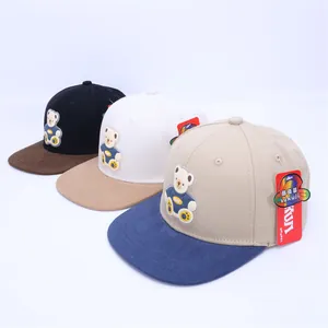 Detailed close-up showing three cartoon bear patches on various colored baseball hats
