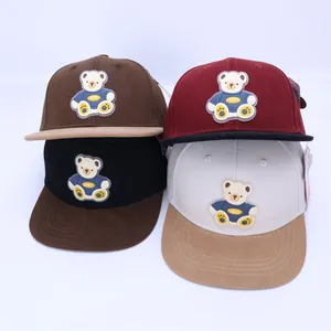 Detail view of four colorful kids hip-hop caps with 3D bear rubber patch design