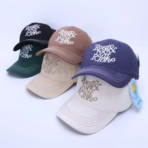 Detail of five cotton baseball caps with letter embroidery in various earthy colors