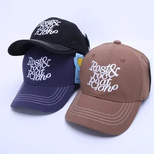 Three cotton baseball caps in black, navy and tan with embroidery and white stitching