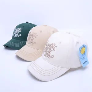 Three children baseball caps in green, beige and white with Lost & Found embroidery