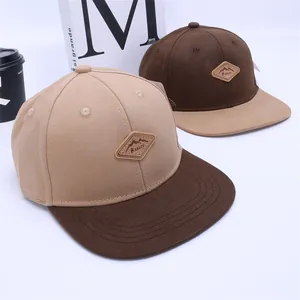Kids flat brim baseball caps in khaki and brown contrast colors with KUKUJI leather patch
