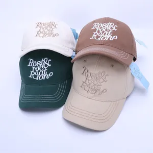 Macro shot of embroidered letters on cotton baseball caps in four stylish colors