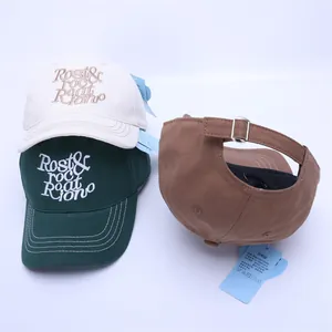 Detail of adjustable cotton baseball caps with metal buckles and 3D letter embroidery