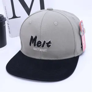Close-up of contrast grey and black snapback hat with 3D Melt letter embroidery