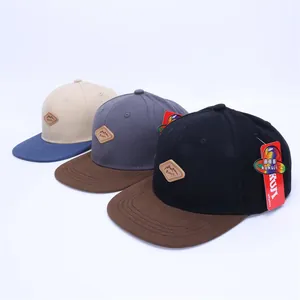 Flat brim baseball cap with mountain leather patch available in three multi-color options