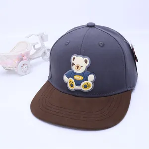 Detailed shot of kids baseball cap featuring 3D rubber bear patch and flat brim design