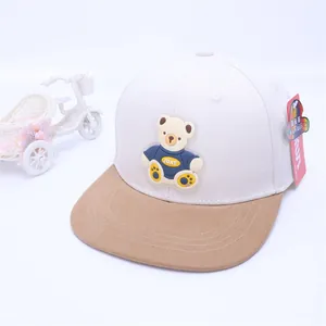 Detail of children's hip hop cap featuring a 3D silicone bear on a white and khaki visor