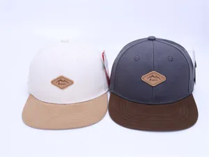 Detail of color-block hip hop caps with mountain patch and flat brim design