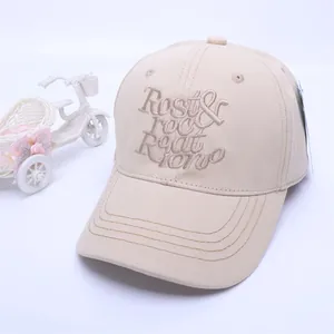 Close-up of beige cotton baseball cap with Rest & Recreation embroidery and a side tag