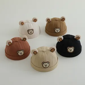 Detailed flat lay of toddler bear ear hats in five neutral colors with cute patches