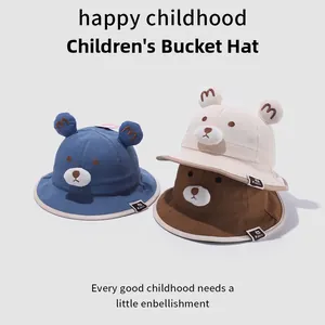 Close-up of cute bear ear bucket hats in blue, cream, and brown breathable cotton fabric