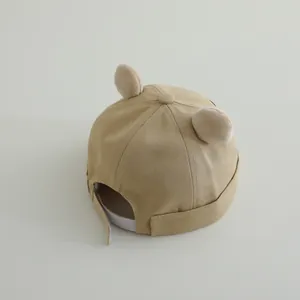 Detailed back view of khaki baby cap with plush bear ears and adjustable velcro strap