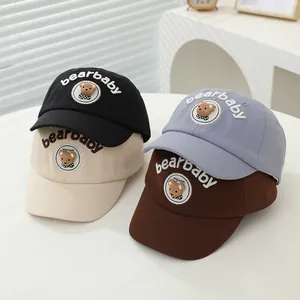 Detail of four colorful cotton baseball caps with bear patches and bearbaby embroidery