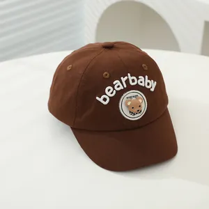 Detail of baby baseball cap with brown cotton fabric and bearbaby 3D embroidery