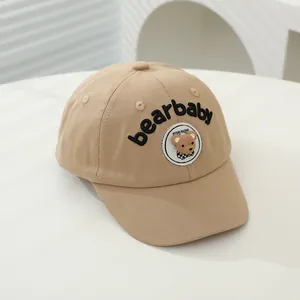 Detailed view of khaki kids baseball cap with bearbaby embroidery and teddy bear patch