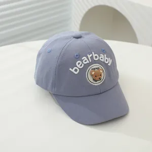 Detailed view of 3D bear embroidery and bearbaby text on a blue kids baseball cap
