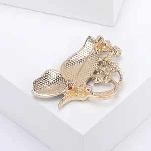 Detail of golden enamel butterfly brooch with crystal inlay and pin back mechanism