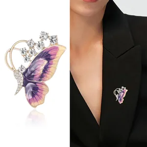Elegant butterfly brooch in purple enamel and gold alloy with sparkling rhinestones