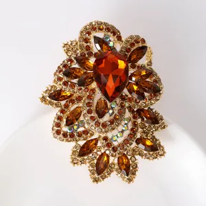 Macro shot of vintage amber crystal flower brooch with marquise stones and gold filigree