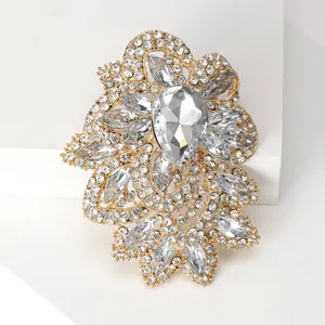 Detailed macro view of vintage baroque brooch with sparkling crystals on a golden base