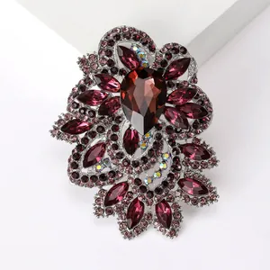 Detailed macro of vintage crystal brooch with garnet red gems and silver alloy setting