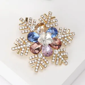 Detail of snowflake brooch with colorful teardrop gemstones and white crystals