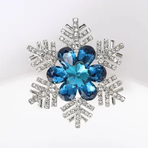 Macro shot of snowflake brooch with blue crystals and glittering rhinestones
