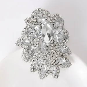 Macro detail of silver crystal brooch with pear-shaped rhinestone and intricate facets