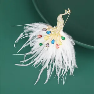 Macro shot of peacock brooch with multicolored crystals and white feather detail