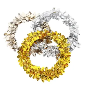 Christmas tinsel garland wreath with metallic berry leaves in gold and silver