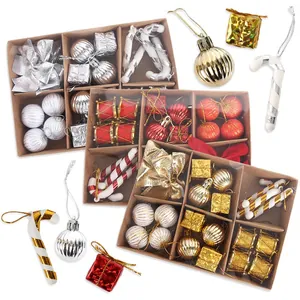 Detail of Christmas tree ornaments kit with red and gold baubles and candy canes in boxes