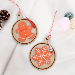 Wooden Christmas gingerbread and snowflake ornaments with red strings for tree decoration