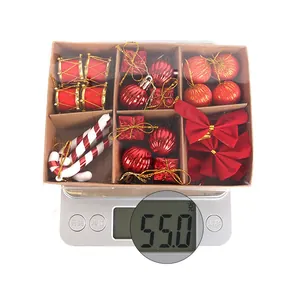 Overhead view of a Christmas decoration set in a kraft box being weighed at 55 grams