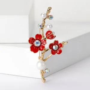 Elegant gold plum blossom branch brooch with red enamel flowers and white pearls
