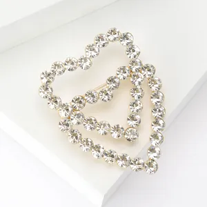 Macro view of double heart hollow brooch with crystal rhinestones on white blocks