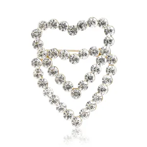 Elegant gold double heart brooch with sparkling rhinestones in a minimalist hollow design