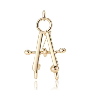 Polished gold alloy compass brooch featuring industrial design on a clean white background