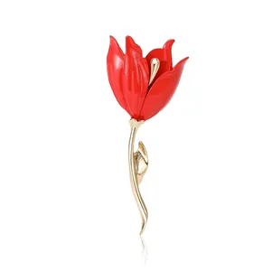 Elegant red enamel tulip brooch with gold finish, floral lapel pin on white background
