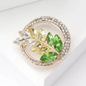 Close-up of golden wreath brooch with multi-colored crystals and sparkling rhinestones