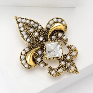 Vintage golden anchor brooch with white pearls and a large square clear zircon crystal