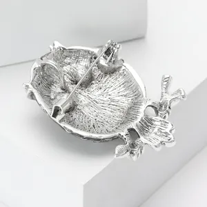 Silver vintage enamel owl brooch showing back view with secure rotary safety pin closure