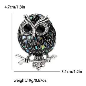 Fashionable enamel owl brooch with abalone shell inlays measuring 4.7cm in height