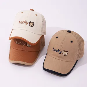 Detailed close-up of lucky bear cartoon embroidery on breathable mesh trucker caps