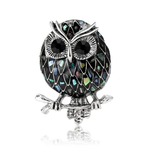 Fashionable owl brooch with silver alloy, iridescent shell inlay and black enamel finish
