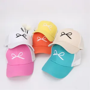 Detail of multi-colored kids mesh baseball caps with bow embroidery and breathable fabric