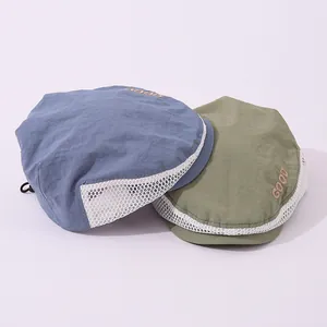 Detail of breathable mesh sides and adjustable drawstring on kids summer beret hats
