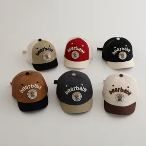 Detailed view of six mesh baby baseball caps with bear embroidery and breathable fabric