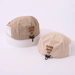Close-up of children's breathable mesh beret with Nice Day embroidery and adjustable drawcord